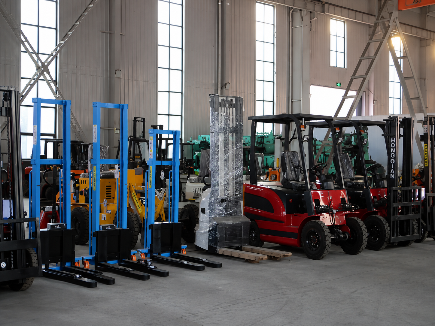 Mast and carriage assemblies staged in the paint and assembly area at Gangchi